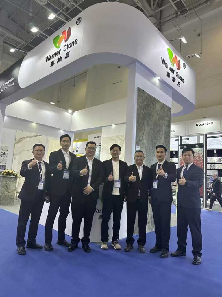 Sales team in business suits giving thumbs-up at an international exhibition
