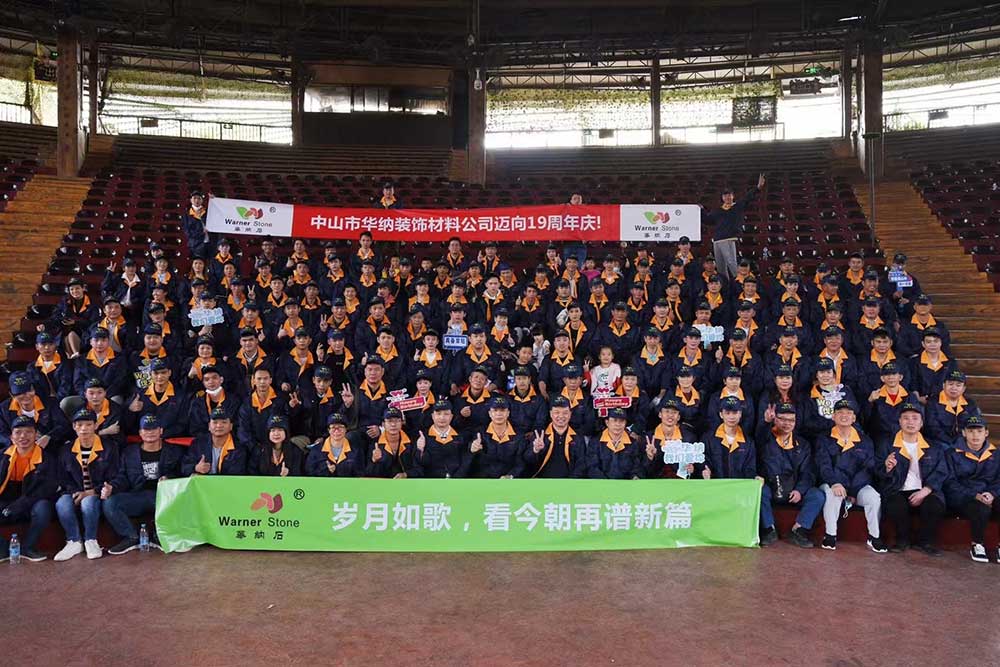 Team photo of all staff celebrating the 19th anniversary at Zhongshan Warner Quartz, dressed in formal outfits
