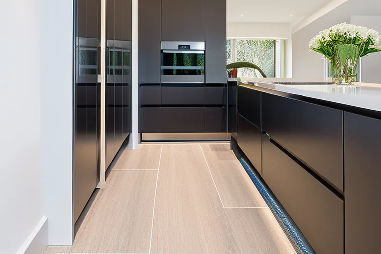 Professional installer measuring a quartz worktop in a kitchen to avoid common fitting errors